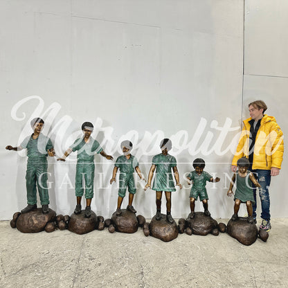 Six Children walking across Stones Bronze Statue Set